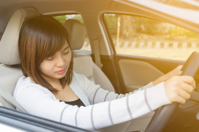 Portrait of woman sitting in car