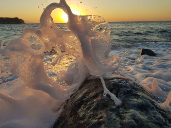 Close-up of sea shore during sunset