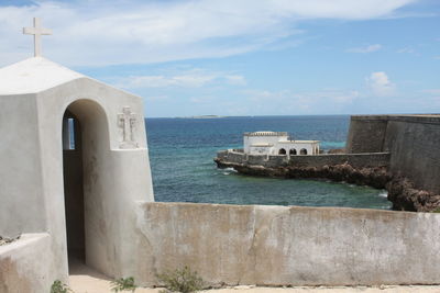 Scenic view of sea by building against sky