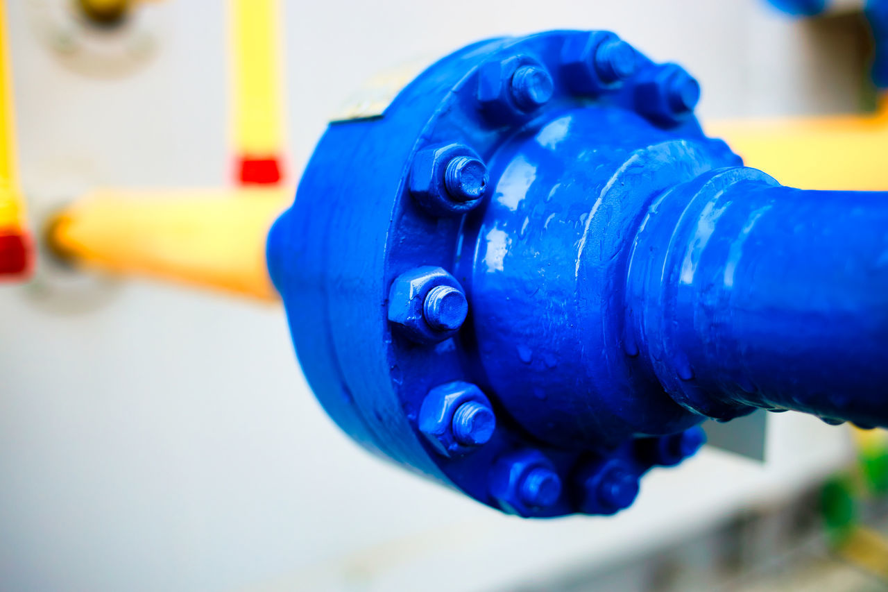 CLOSE-UP OF WATER DROPS ON METALLIC PIPE