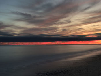 Scenic view of sea against romantic sky at sunset