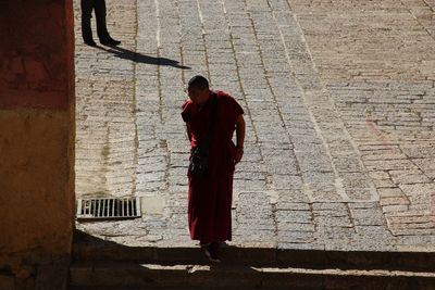 Rear view of man walking on cross