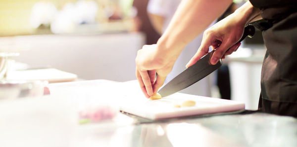 Cropped image of people working on table