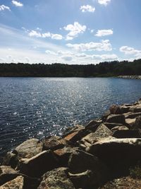 Scenic view of river against cloudy sky