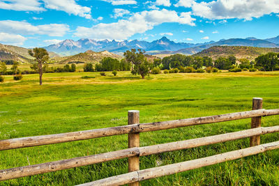 Fence on field against sky