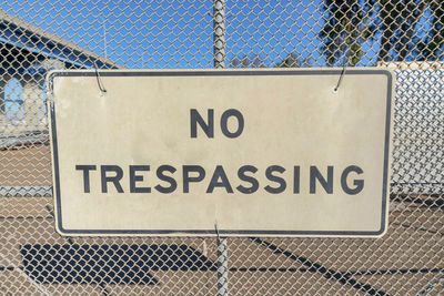 Close-up of text on chainlink fence