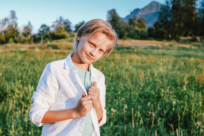 Portrait of boy standing on field