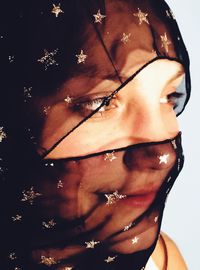 Close-up of young woman against white background