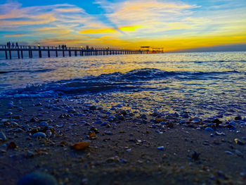 Scenic view of beach against sky during sunset