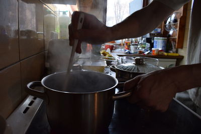 Close-up of man preparing food in kitchen