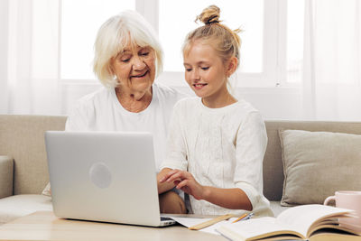 Young woman using laptop at home