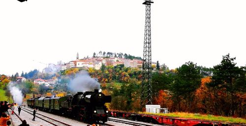 Train on railroad tracks against clear sky