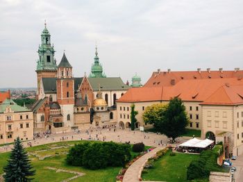People at wawel cathedral against sky