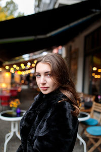 Portrait of young woman standing outdoors