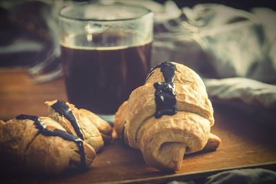 Close-up of croissants with coffee on table