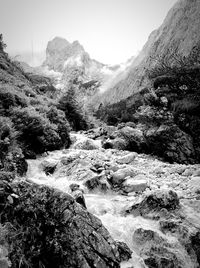 Scenic view of river amidst mountains against clear sky