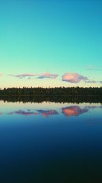 View of calm lake against blue sky