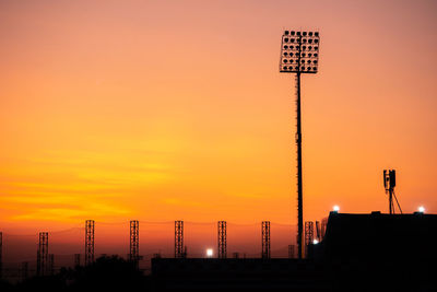 Low angle view of road sign against sky during sunset