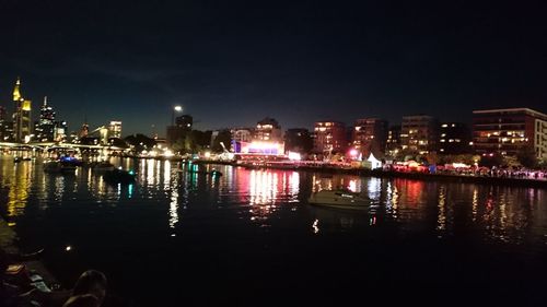 Boats in river with buildings in background