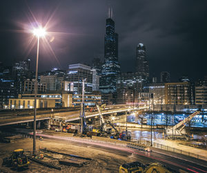 Illuminated city against sky at night