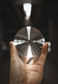 Close-up of hand holding crystal ball