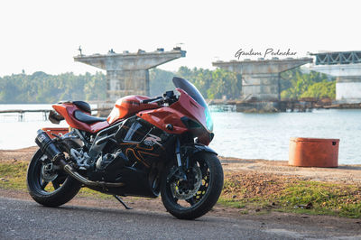 Man on motorcycle against built structure