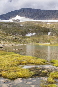Scenic view of lake and mountains against sky