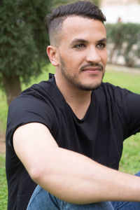 Man sitting on grass at park