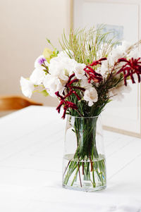 Close-up of white flower vase on table at home