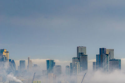Modern buildings in city against sky