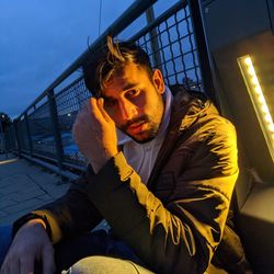 Portrait of young man sitting outdoors