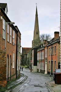 Street amidst buildings against sky in city