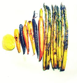 High angle view of multi colored candies against white background