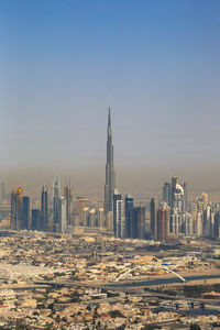 Modern buildings in city against clear sky