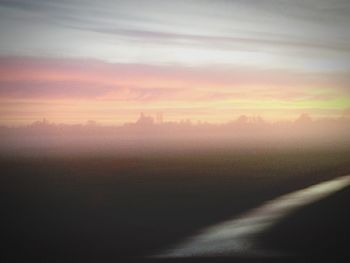 Scenic view of landscape against sky during sunset