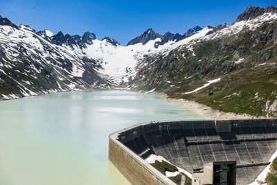 Oberaarsee dam and oberaar glacier near grimsel pass in a beautiful summer day, switzerland