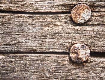 Close-up of rusty nails on wooden table