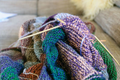 Close-up background image of a variegated knitted blanket with a colorful graphic design