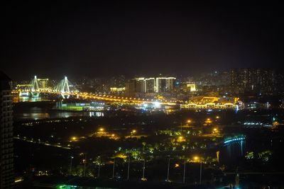 High angle view of illuminated buildings against sky at night