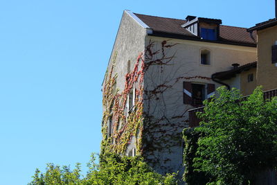 Low angle view of house against clear blue sky