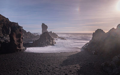 Full frame view of sun over volcanic shoreline