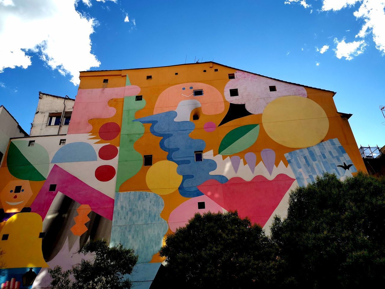 LOW ANGLE VIEW OF MULTI COLORED BUILDING