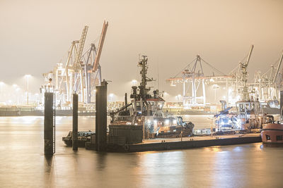 Commercial dock by sea against sky