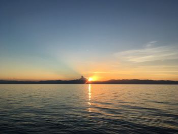 Scenic view of sea against clear sky during sunset