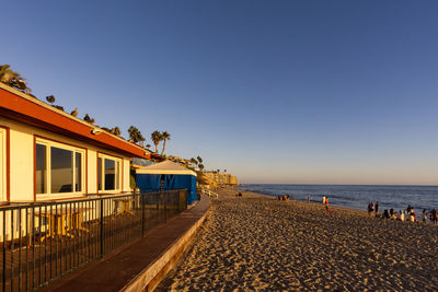 Scenic view of beach against clear blue sky