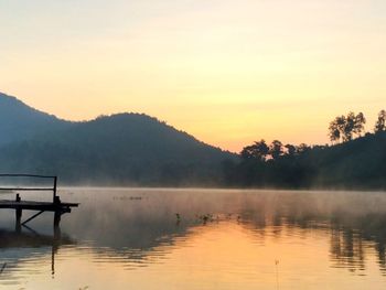 Scenic view of lake at sunset