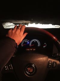 Close-up of human hand in car