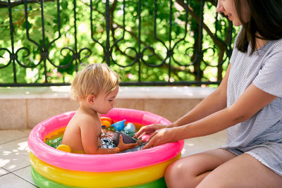 Midsection of woman playing with toy sitting outdoors