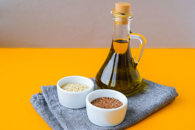 Sesame and flax seeds with oil in glass bottle. healthy food concept. vegan keto diet. healthy eatin