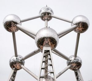 Low angle view of communications tower against sky